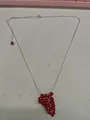 Elegant silver-tone necklace featuring a unique cluster of vibrant red grape glass beads. - Red