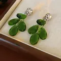 Elegant vintage emerald green teardrop crystal earrings with sparkling rhinestone studs - Clip-on Earrings / Green