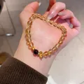 Detailed shot of yellow citrine bead bracelet with a red agate and golden flower charm - Yellow Crystal Flower (WB611) / 8mm Bead Diameter - With Gift Box