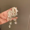 Elegant long tassel earrings with faux pearls and iridescent petal charms in gold finish. - 39# Silver Needle - White - Pearl Shell Tassel