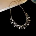Detailed view of an elegant lace-style necklace featuring pearls and sparkling rhinestones - French Vintage Pearl Tassel (HN10486) / Silver