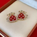 Close-up of gold-plated lucky bag stud earrings with pearls and red enamel - Stud Earrings / Gold And Red