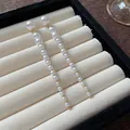 Detail of elegant long pearl tassel drop earrings in a velvet jewelry box - French Vintage Tassel Style (HE24475) / Gold, White