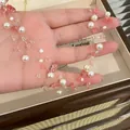 Detail of a strawberry crystal and pearl beaded necklace with pink and white tones. - Necklace / Pink-White