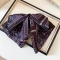 Detailed view of a vintage paisley pattern bow hair clip presented in a display tray - Hair Claw / Black