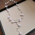 Detailed view of an elegant three-layer French necklace with irregular white pearls - Triple Layered Style / Silver