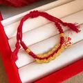 Detailed view of red braided rope bracelet with golden coins and horse pendant - Traditional Coin Horse (Style 23)