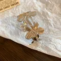 Close-up view of a silver floral leaf open cuff bracelet showing detailed metallic finish - Flower Shape / Silver