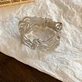 Detail showing the intricate hollow flame pattern of the silver metal cuff bracelet - Hollow Leaf (With Clasp) / Silver