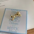 Elegant gold-toned metal bow-shaped hair clip for fringe and side hair styling accents - Gold Bow Style / Gold
