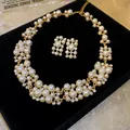Close-up of vintage pearl and rhinestone necklace and earring jewelry set on black velvet - Necklace and Earring Set / Gold