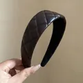 Detailed view of brown quilted leather padded headband with high cranial top effect - Brown