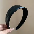 Detail view of black quilted leather headband showing fine stitching and padded design. - Black