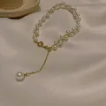 Detailed macro view showing the elegant craftsmanship of a gold chain pearl bracelet - 29# Bracelet / Gold - Double Row