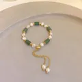 Detailed view of an elegant freshwater pearl and green bead bracelet with gold tassel accents - 43# Bracelet / Green-Bamboo Joint
