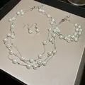 Elegant three-piece pearl jewelry set featuring multi-strand necklace bracelet and earrings - Three-Piece Set / Silver/White