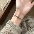 Elegant adjustable black cord bracelet featuring a vibrant round green zircon stone - 14# Bracelet (Round Zirconia Black Cord)