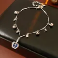 Silver adjustable bracelet featuring a blue crown pendant and small charms on a black base - 24# Bracelet (Crown Bell)