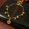 Elegant gold adjustable bracelet featuring small bells, crystals, and a blue crown charm - 23# Bracelet (Crown Bell)