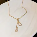 Detailed view of gold calabash tassel necklace with sparkling zircon inlay - Gold