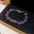 Elegant oval purple cubic zirconia bracelet with silver setting on black velvet. - Style 16 Bracelet