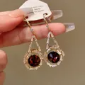 Macro view of vintage earrings with deep red stones and clear zircon halo - Vintage Ear Hook Style (5#)