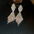 Luxurious silver-tone statement earrings with cascading rhinestone tassels and geometric design. - 56# Silver Earring Post - Silver White