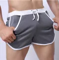 Close-up detail of grey mesh athletic shorts with white trim and adjustable drawstring waist - M / Dark Gray