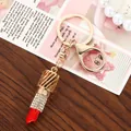 Detailed close-up of a glamorous lipstick keychain charm with sparkling rhinestones - White Rhinestone Inlaid Lipstick Shape / Silver