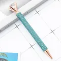 Elegant rose gold ballpoint pen fully covered in blue rhinestones with a large crystal. - 1.0mm Bullet Tip / Lake Blue