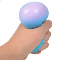 Soft rainbow gradient TPR stress relief squeeze ball being hand squeezed for anxiety - Blue Color Liquid Ball
