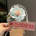 Elegant light blue artificial flower ballpoint pen decoration in clear gift bag packaging - Camellia Pen (Ice Blue)