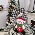 Detailed view of a cute snowman plush Christmas tree ornament with a black and white bow - Snowman