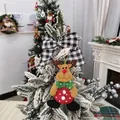Detailed close-up of a festive reindeer ornament on a snowy Christmas tree branch - Reindeer Doll