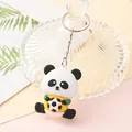 Detailed macro view of a cute cartoon panda keychain holding a black and white soccer ball - Sport Panda - Soccer