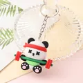 Close-up of a cute cartoon panda keychain lifting weights and wearing a red headband - Sport Panda - Weightlifting