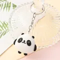 Close-up of a cute cartoon panda keychain with a silver metal ring. - Round Panda A