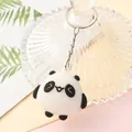 Detailed close-up of a cute cartoon panda keychain with round black and white body - Round Panda B