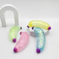 Glittery maltose syrup banana squishy toy in four colors for stress relief. - Maltose Banana