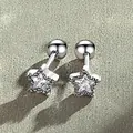 Close-up detail of silver star-shaped screw-back earrings with sparkling zircon center - White Rhinestone Star Stud Earring (Silver Tone)