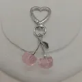 A cute pink cherry-shaped keychain with heart-shaped metal clasp for bags and phones. - Heart Pink
