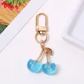 Cute blue glitter resin cherry keychain with gold metal leaf accessory for bags and keys - KC Gold Lake Blue