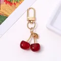Exquisite glittering red resin cherry keychain pendant with gold metal hardware for bags - KC Gold Dark Red