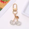 Cute sparkling clear cherry keychain with silver glitter inside and gold finish. - KC Gold White
