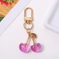 Charming purple glitter cherry keychain with elegant gold clasp for bags and keys - Purple
