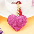 Close-up of a sparkling pink rhinestone heart keychain with a matching tassel - Gold + Deep Rose Red