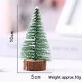 Detailed view of a mini flocked Christmas tree showing its 10cm height and 5cm width - 10cm