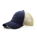 Detailed side view of washed cotton trucker hat with navy blue brim and beige mesh back - Navy Blue