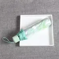 Green foldable daisy umbrella with clear sleeve in light mint finish - Manual Sakura Green Transparent