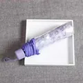 Compact purple folding umbrella with white daisy patterns in clear storage sleeve - Manual Sakura Purple Transparent